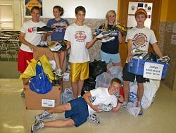 Judge Memorial Catholic High School athletic teams donate shoes to an athletic club in South Africa 